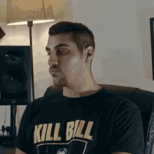 a man wearing a black kill bill shirt