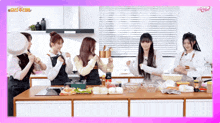 a group of women are cooking in a kitchen with a pink border that says ' a ' on it