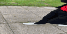 a person walking down a sidewalk wearing white shoes