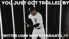a baseball player in a white sox uniform is dancing in front of a white background .