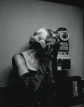 a woman is talking on a pay phone that says " talk " on it