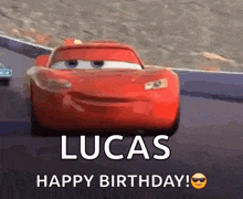 a red car from the movie cars is driving down a race track and says happy birthday lucas .