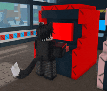 a person playing an arcade game with a red box that says ' a ' on it