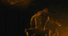 a man is holding a woman in a dark room
