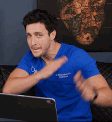 a man wearing a blue scrub top that says dr. mikhail volkovski d.d.s.