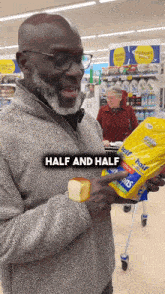 a man holding a bag of half and half