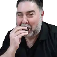 a man with a beard is eating a cookie