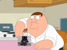 peter griffin is sitting at a table with a stuffed animal