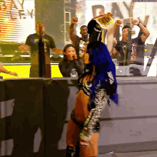 a woman with blue hair is holding a bag of chips in her hand