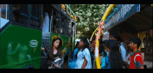 a group of people are waiting at a bus stop with a sign that says ' a ' on it