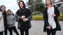 a group of young men standing next to each other in a parking lot