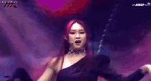 a woman with red hair is singing into a microphone on stage
