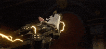 a woman is flying through the air with a lightning bolt coming out of her hand .