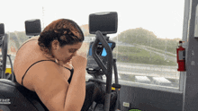 a woman is riding an elliptical machine that says ne on the side