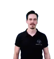 a man wearing a black shirt that says coach on it waves his hand