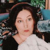a woman wearing headphones is holding a stuffed animal .