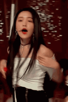 a woman with long black hair is dancing on a stage .