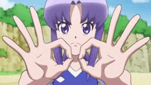 a girl with purple hair makes a heart shape with her hands