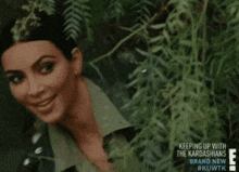 a picture of kim kardashian with the words keeping up with the kardashians on the bottom