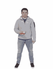 a man is standing in front of a white background and holding a bottle of soda .