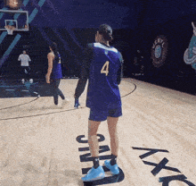 a basketball player wearing a number 4 jersey stands on a court