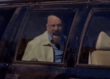 a man with a beard is sitting in the back seat of a car .