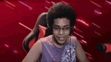a man is dancing in front of a red background .