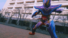 a person in a purple and orange costume is standing on a sidewalk in front of a building