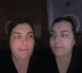 a woman with a nose ring looks at the camera in a dark room