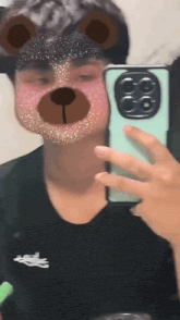 a young man is taking a selfie with a teddy bear mask on his face