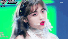 a girl is wearing a headband and a microphone on a stage with the words count down everglow in the corner