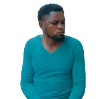 a man with a beard wearing a blue sweater