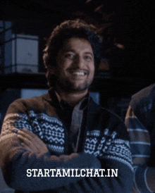 a man in a sweater is smiling and the website starttamilchat.in is displayed below him