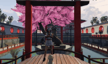 a woman in a plaid skirt stands under a cherry blossom tree