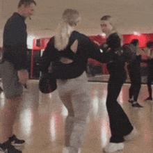 a group of people are dancing in a room