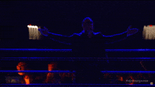 a crowd of people watching a wrestling match with the hashtag # njtsurgenc on the bottom