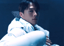 a man is wearing a white jacket with the number 10 on the front