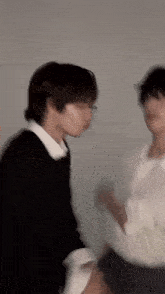 a blurry picture of two people standing next to each other .