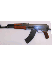 an assault rifle with a wooden grip on a white surface