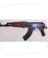 an assault rifle with a wooden grip on a white surface