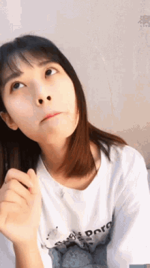 a girl wearing a white shirt that says poro