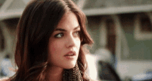 a close up of a woman 's face with a shocked look on her face .