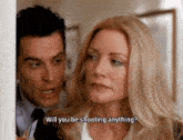 a man and woman are standing next to each other and the woman is asking the man if he will be shooting anything