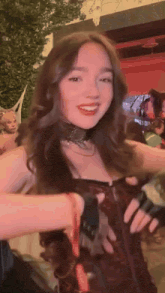a woman in a corset and gloves is smiling for the camera