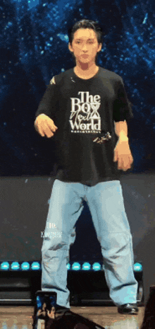 a man wearing a black shirt that says the box world is dancing on stage