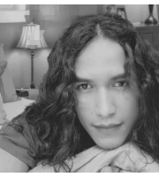 a black and white photo of a man with long hair