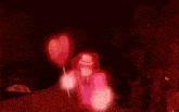 a person holding a pink heart shaped balloon in a video game .