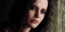 a close up of a woman 's face with a sad look on her face