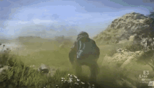 a person is walking through a field with a youtube logo on the bottom right