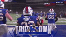 a buffalo bills football player named ray davis stands on the field